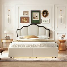 a white bed sitting in a bedroom on top of a hard wood floor