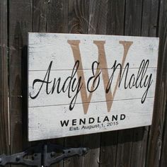 a wooden sign that says andy and matilda on it, with the word wedland written in cursive font