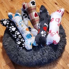 a dog bed filled with lots of different types of dogs'paw prints on it