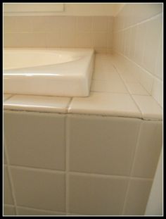 the corner of a bathroom with white tile