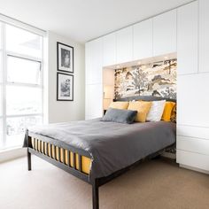 a bedroom with white walls and yellow accents