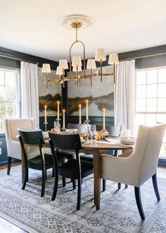 a dining room table with chairs and a chandelier