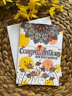 congratulations and best wishes card with yellow flowers on woven wicker basket next to it