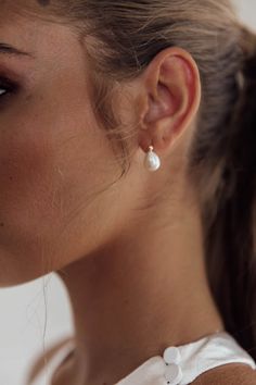 a close up of a person wearing earrings