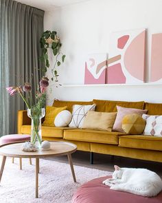 a living room filled with furniture and large windows