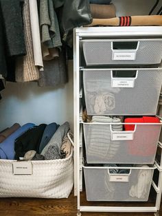 an organized closet with clothes and other items in bins on the shelf next to it