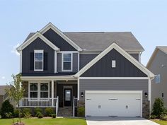 a large house with two garages in the front and one on the other side