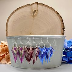 "These feminine and elegant fringe earrings are made with a gorgeous color palette of purple, pearl, and metallic and transparent mix of purple and green. They measure 3.375\" long x 1.25\" wide from the top of the fishhook ear wire to the tip of the longest fringe. They come with silicone earring backs. Earrings are best stored upright or laying flat to avoid wrinkling of the beaded fringe.  Lead and nickel Free Hypoallergenic  These colorful fringe earrings are made with: * Preciosa PermaLux D Purple Jewelry With Beaded Fringe And Round Beads, Purple Beaded Fringe Drop Earrings, Silver Fringe Beaded Earrings With Round Beads, Purple Beaded Fringe Earrings As Gift, Silver Beaded Earrings With Fringe And Round Beads, Purple Earrings With Beaded Fringe, Purple Beaded Fringe Dangle Tassel Earrings, Purple Fringe Beaded Earrings As Gift, Purple Fringe Beaded Earrings For Gift