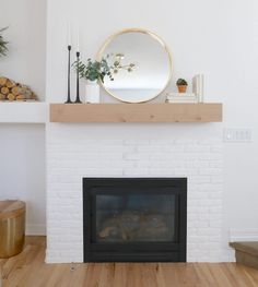 a white brick fireplace with a mirror above it