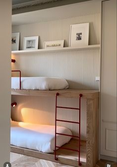 two bunk beds with white sheets and pillows in a room that looks like it has been built into the wall