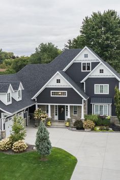 an aerial view of a large house with lots of trees and shrubs in the front yard