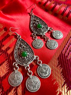 "Brand new dangling earrings from Kyrgyzstan. Traditional Central Asian design . Have a taste of ancient Silk Road in your collection.  Brand new dangling earrings in traditional design from Central Asia (Kyrgyzstan, Kazakhstan, Uzbekistan) Perfect & unique addition to your collection or ideal for gift. Length: 3\" Wide: 1.5\" Stone in green color. Treat yourself or someone you love with outstanding ancient Silk Road design. Very light & we ship worldwide." Metal Chandelier Earrings For Festivals, Metal Danglers With Latkans For Gift, Traditional Nickel-free Metal Chandelier Earrings, Traditional Pierced Danglers As Gift, Traditional Handmade Chandelier Earrings As Gift, Traditional Handmade Green Chandelier Earrings, Handmade Traditional Chandelier Earrings As Gift, Ornate Chandelier Earrings With Latkans For Gift, Bohemian Teardrop Danglers For Gifts