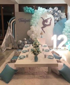 a table set up with balloons and decorations