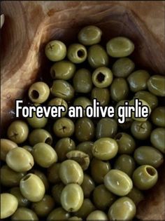 green olives in a wooden bowl with the words forever an olive girl