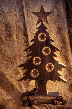 a wooden christmas tree with stars on it