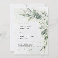 a wedding card with greenery on it