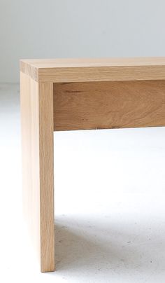 a close up of a wooden table on a white surface with no one around it