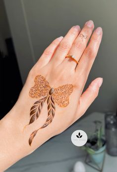 a woman's hand with hendi tattoos on it