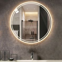 a bathroom with a round mirror on the wall next to a sink and counter top