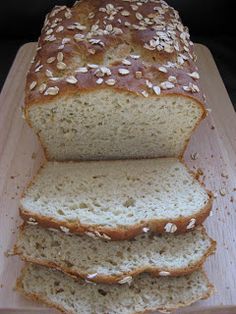 a loaf of bread sitting on top of a wooden cutting board