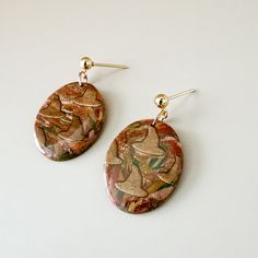 Each pair of Clay + Cause earrings is a hand-made, one of a kind piece! This means your earrings may not be identical to the photograph. Colors and patterns may appear slightly different in person. We can't wait for you to wear your new earrings! Artsy Brown Drop Earrings, Brown Artsy Earrings, Artsy Brown Earrings With Ear Wire, Handmade Artistic Brown Earrings, Artistic Handmade Brown Earrings, Earthy Drop Earrings For Gift, Earthy Style Drop Earrings For Gift, Artsy Hand Painted Copper Earrings, Hand Painted Copper Artsy Earrings