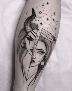 a woman's leg with a black and white tattoo design on the side of her thigh