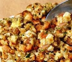 a close up of food in a bowl with a spoon