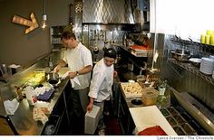 two men are in the kitchen preparing food