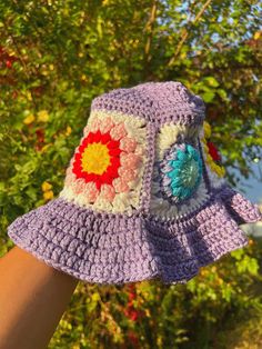 This bucket hat was handcrafted and meticulously stitched together using a healthy blend of 100% cotton and acrylic yarn. Each granny square was created from scratch and then crocheted together to form the classic bucket hat design. One Size Fits Most. Yarn is Strechable. Purple Bucket Hat, Crochet Bucket Hats, Bucket Hat Design, Hat Design, Bucket Hats, Acrylic Yarn, Granny Square, From Scratch, Caps Hats