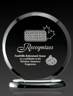 a black and silver award plaque sitting on top of a metal stand with the words recognition