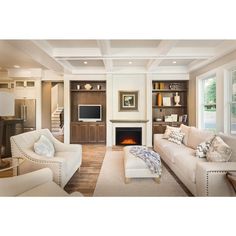 a living room filled with furniture and a fire place in the middle of it's walls