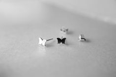 "Gorgeous traditional tiny butterfly stud earrings have been hand crafted from all sterling silver materials. These studs measure approx. 5.5mm x 6mm and are 24 gauge thick. The sterling silver post is the standard 10 mm in length and is 0.8 mm thick. Silver butterfly studs would make a lovely addition to your everyday wardrobe, or the perfect gift for nature lovers. All of my jewelry is handmade, please allow for small variances from piece to piece, as this is a feature of owning one of a kind Minimalist Butterfly Earrings For Everyday Wear, Minimalist Butterfly Earrings For Everyday, Minimalist Butterfly Charm Earrings For Gift, Minimalist Butterfly Charm Earrings Gift, Silver Dainty Butterfly Earrings, Tiny Butterfly Sterling Silver Jewelry, Tiny Sterling Silver Butterfly Jewelry, Minimalist Butterfly Charm Earrings, Dainty Tiny Butterfly Earrings