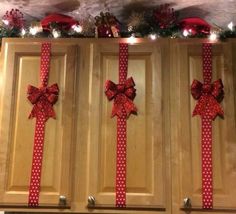 a kitchen decorated for christmas with red bows and lights on the wall above it is an instagram