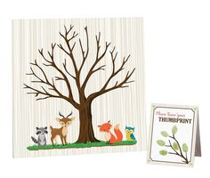 a card with an image of a tree and two animals on it, next to a greeting card