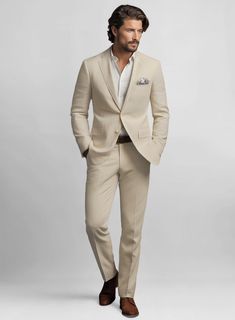 To look your smartest even on those hot days, all you need is to invest in our Sand Feather Cotton Canvas Stretch Suit. Crafted from cotton and lycra blend, the suit can be worn whenever you are ready to kick your stylish charm up a notch with great enthusiasm. Wear it at a wedding party or any special occasion. 
 
 Look Includes  Sand Feather Cotton Canvas Stretch Fabric  Two Button Jacket Style  Notch Lapel  Corozo Beige Buttons  Single Vent  Three Cuff Buttons  Two Welted Back Pockets on Trousers   You can change the look during customization if required. 
 
Lining: Viscose; Dry Clean. Classic Beige Semi-formal Sets, Custom Fit Notch Lapel Sets For Business Casual, Tailored Beige Sets For Business Casual, Chic Linen Business Suits, Classic Fitted Beige Suit, Classic Summer Workwear Sets, Fitted Beige Suit For Business Casual, Classic Slim Fit Summer Blazer, Classic Summer Slim Fit Blazer