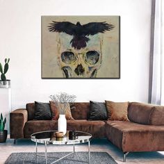 a living room with a couch, coffee table and painting on the wall above it