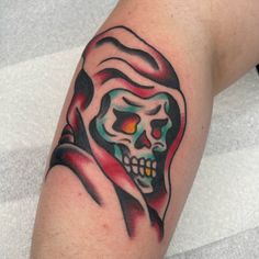 a man's arm with a colorful skull on it and a red rose in the middle