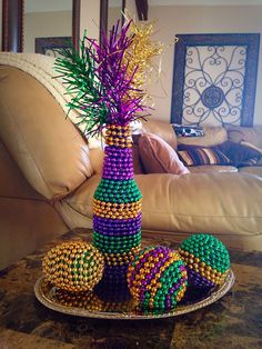 beaded decorations on a tray in front of a couch