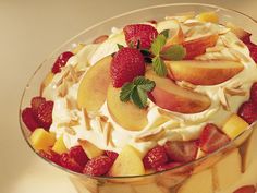 a dessert with fruit and whipped cream in a glass dish