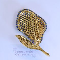 Thank you for coming in! Stunning Yellow 18k Gold Vintage Blue Sapphire Diamond Calla Lily Flower Bouquet Brooch! There are 215 total blue sapphire rounds totaling 22.54 carats and 2.2 carats of round sparkly white diamonds. Total Weight: 26.83grams Size: 2.5 inches tall, 1.5 inch wide Precious Metal: 18k white gold Precious stones: -Sapphires: 22.54 carats, QTY 215 -White Round Diamonds: 2.2 carats Hallmark: 18k Blue Sapphire Brooches As Gift, Blue Sapphire Brooch For Gift, Blue Sapphire Brooches For Gift, Elegant Sapphire Brooch For Gift, Luxury Sapphire Brooches As Gifts, Luxury Sapphire Brooches For Gift, Lily Flower Bouquet, Calla Lily Flower, Bouquet Brooch