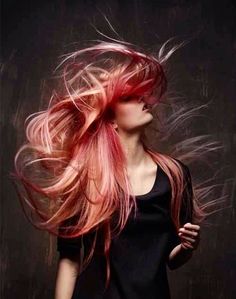 a woman with pink hair blowing in the wind