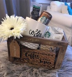 a wooden crate filled with coffee and other items on top of a fur covered bed