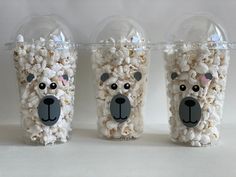 three plastic cups filled with popcorn shaped like bears