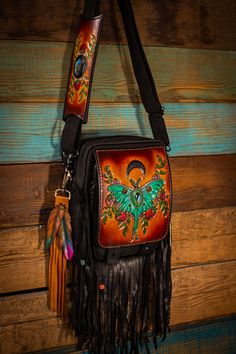 THIS BAG IS MADE TO ORDER This unique bag, was handmade from my favorite quality, oil-tanned, crazy-horse leather, and lined with heavy canvas. This bag is durable and amazingly functional at the same time. The front flap and matching shoulder-piece were hand tooled, dyed, and inlaid with 2 gorgeous labradorite gemstones! It features a large zippered front pocket, a zippered back pocket, and large main pouch with another small zippered pocket, and un-zippered small compartment. This bag also com Painted Purses Ideas, Gothic Bags, Natural Leather Bag, Shoulder Piece, Gothic Bag, Feather Fringe, Painted Purse, Handbag Hanger, Holster Bag