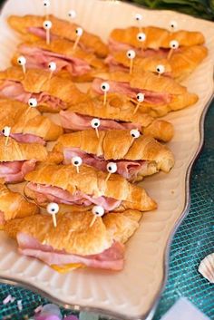 there are many croissants with googly eyes in them on a plate