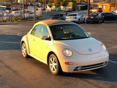 a small white car parked in a parking lot