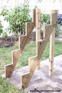 a wooden staircase made out of wood planks on the ground in front of a house