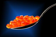 a spoon full of orange gummy bears