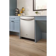 a white dishwasher sitting in a kitchen next to a counter top and cabinets