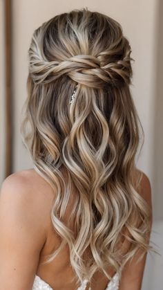 a woman with long blonde hair wearing a wedding dress and braided in half - up